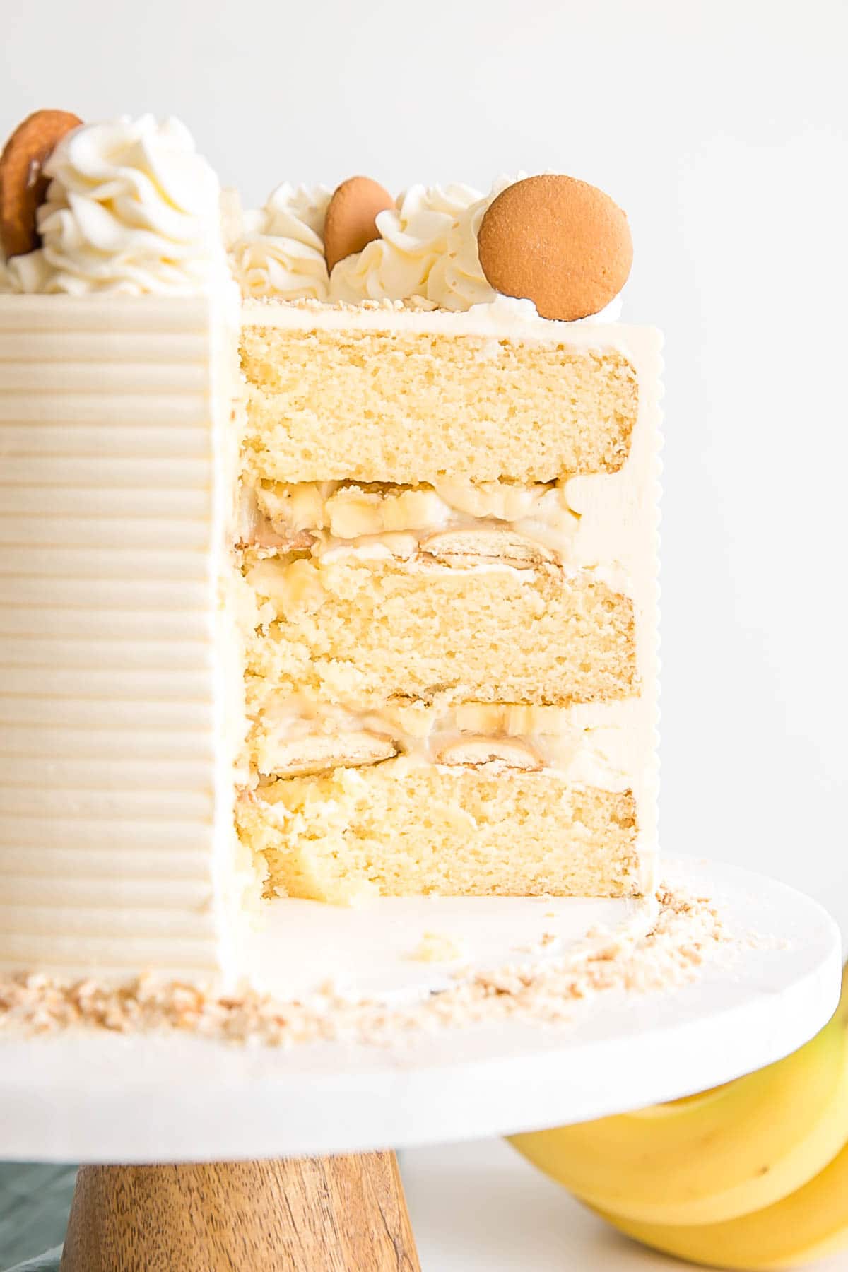This Banana Pudding Cake combines all of the elements of the classic southern dessert. Vanilla cake, banana pudding, and vanilla wafers with vanilla buttercream and fresh whipped cream. | livforcake.com Cross section of Banana Pudding Cake.