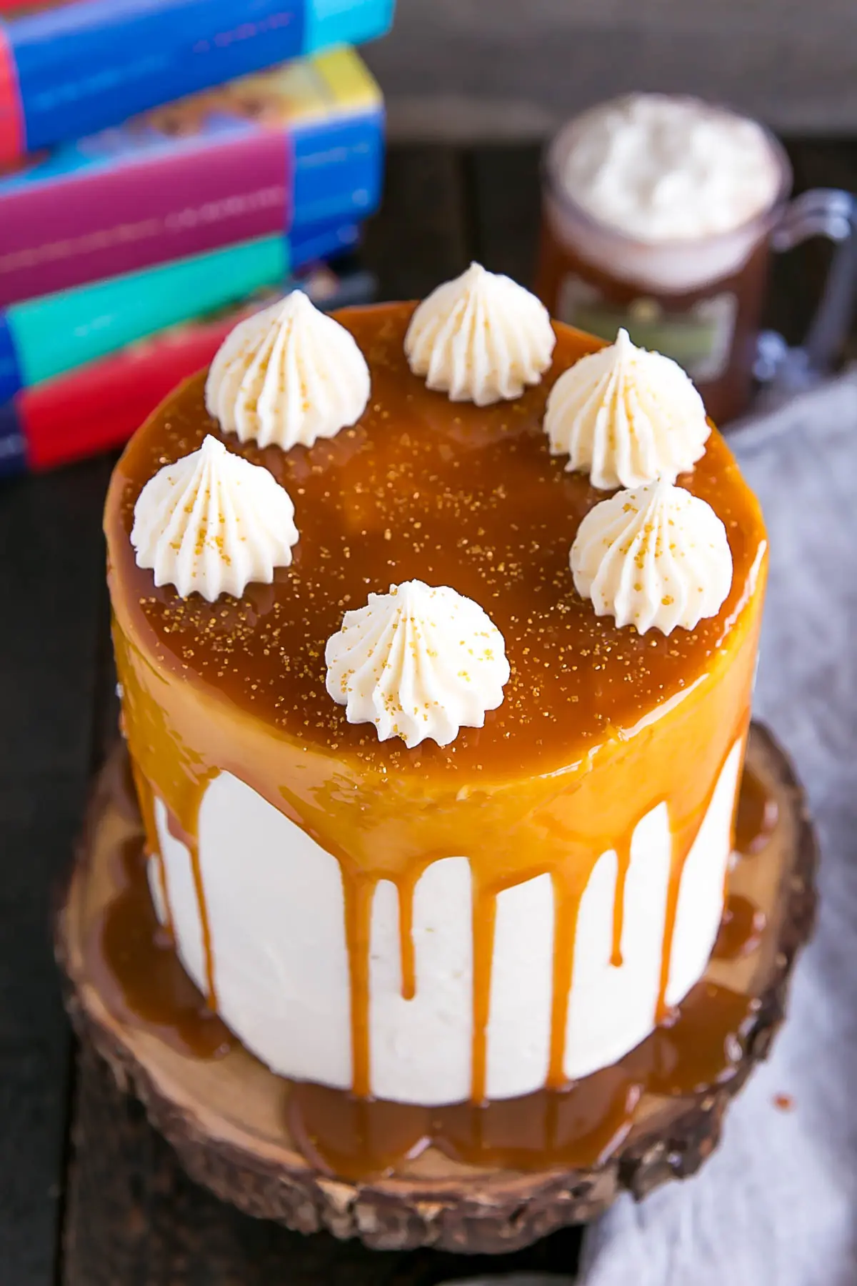 Harry Potter Cake! This Butterbeer cake combines butterscotch, cream soda, and marshmallow all in one spellbinding dessert. | livforcake.com Harry Potter Butterbeer Cake with gold sprinkles.