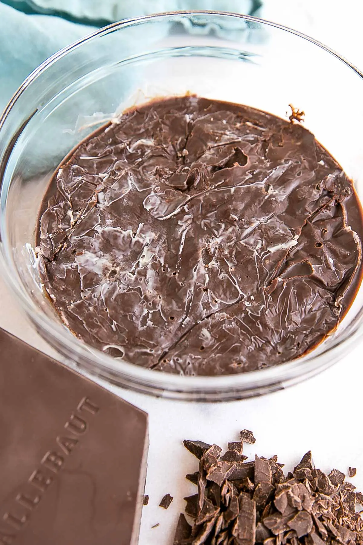 How to make Chocolate Ganache! A simple, two-ingredient recipe for a delicious frosting, filling, drip, or glaze. | livforcake.com Split ganache with a layer of solidified cocoa butter on top.