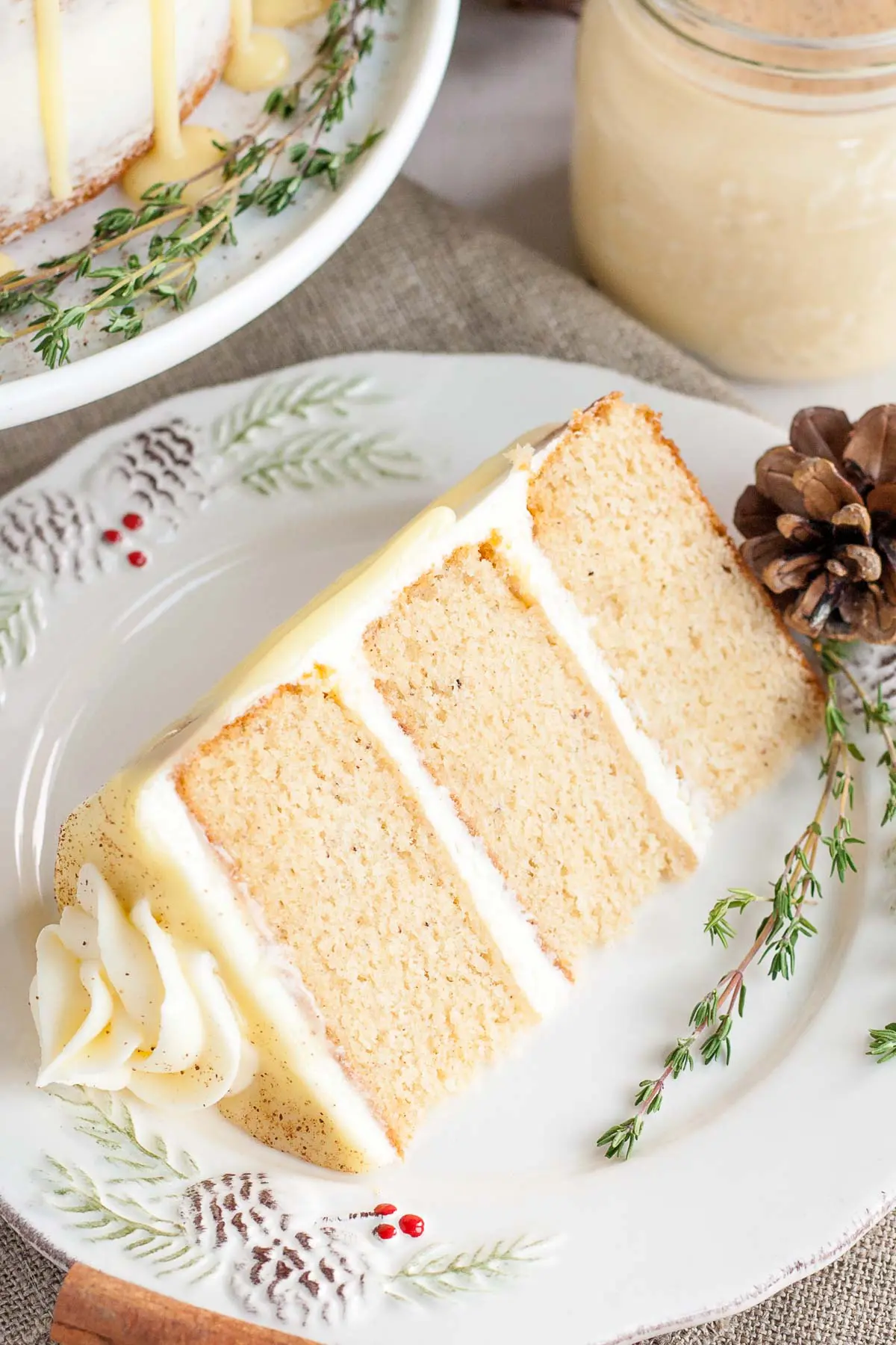 This Eggnog Cake with cream cheese frosting and white chocolate ganache is just the thing to warm you up this Holiday season! | livforcake.com Eggnog cake slice.
