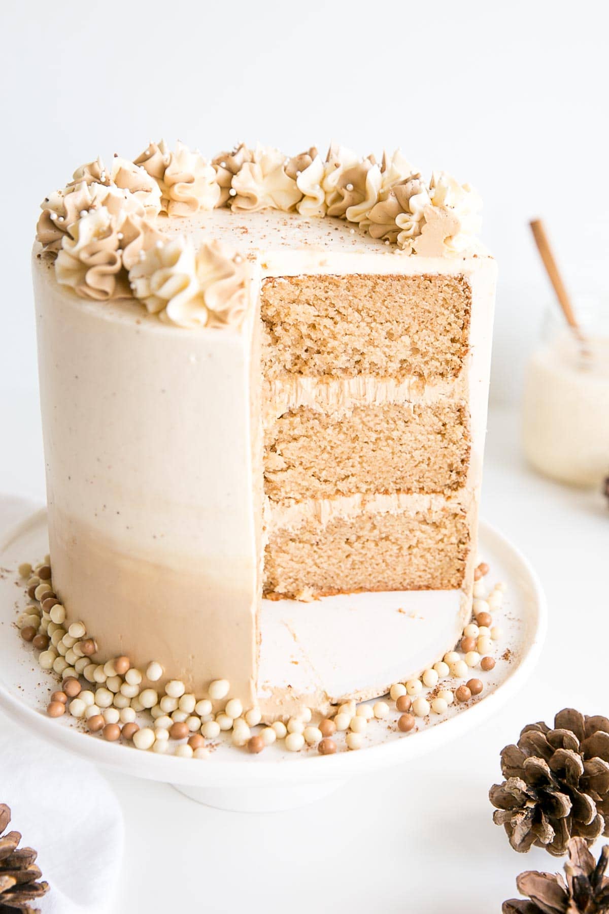 Eggnog Latte Cake! Transform a favourite holiday beverage into a decadent dessert with this Eggnog Latte Cake! Eggnog infused cake layers paired with eggnog and espresso buttercreams. | livforcake.com Angled cross-section shot of the cake.