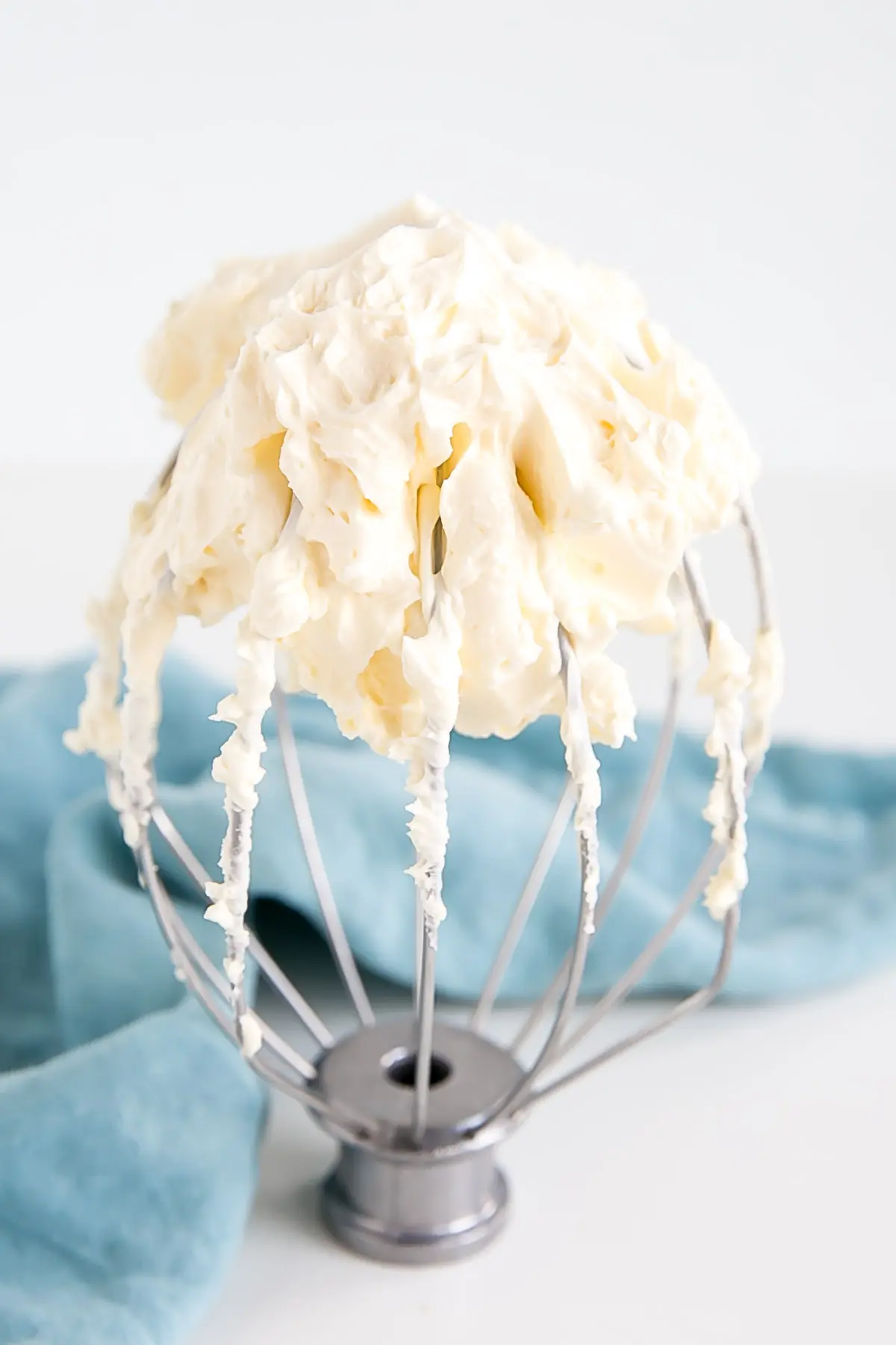 This custard-based German buttercream is made with just a few simple ingredients. Perfect for those who like a rich and silky frosting that isn't too sweet! | livforcake.com German buttercream on a whisk.