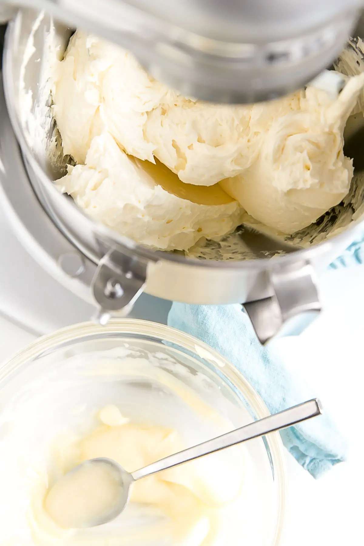 This custard-based German buttercream is made with just a few simple ingredients. Perfect for those who like a rich and silky frosting that isn't too sweet! | livforcake.com Mixer with bowl of pastry cream and spoon next to it.