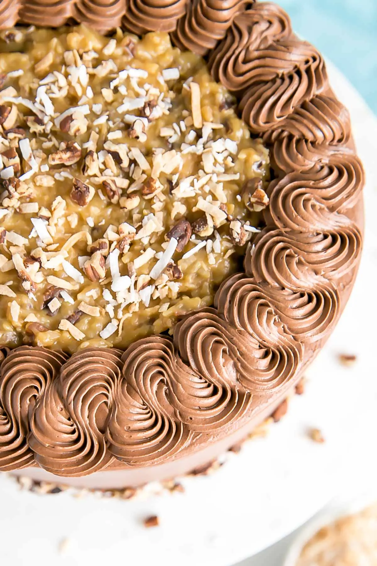 This Classic German Chocolate Cake combines rich chocolate cake layers with a sweet coconut pecan filling and a dreamy chocolate buttercream. | livforcake.com Overhead shot and close up of the rope border.