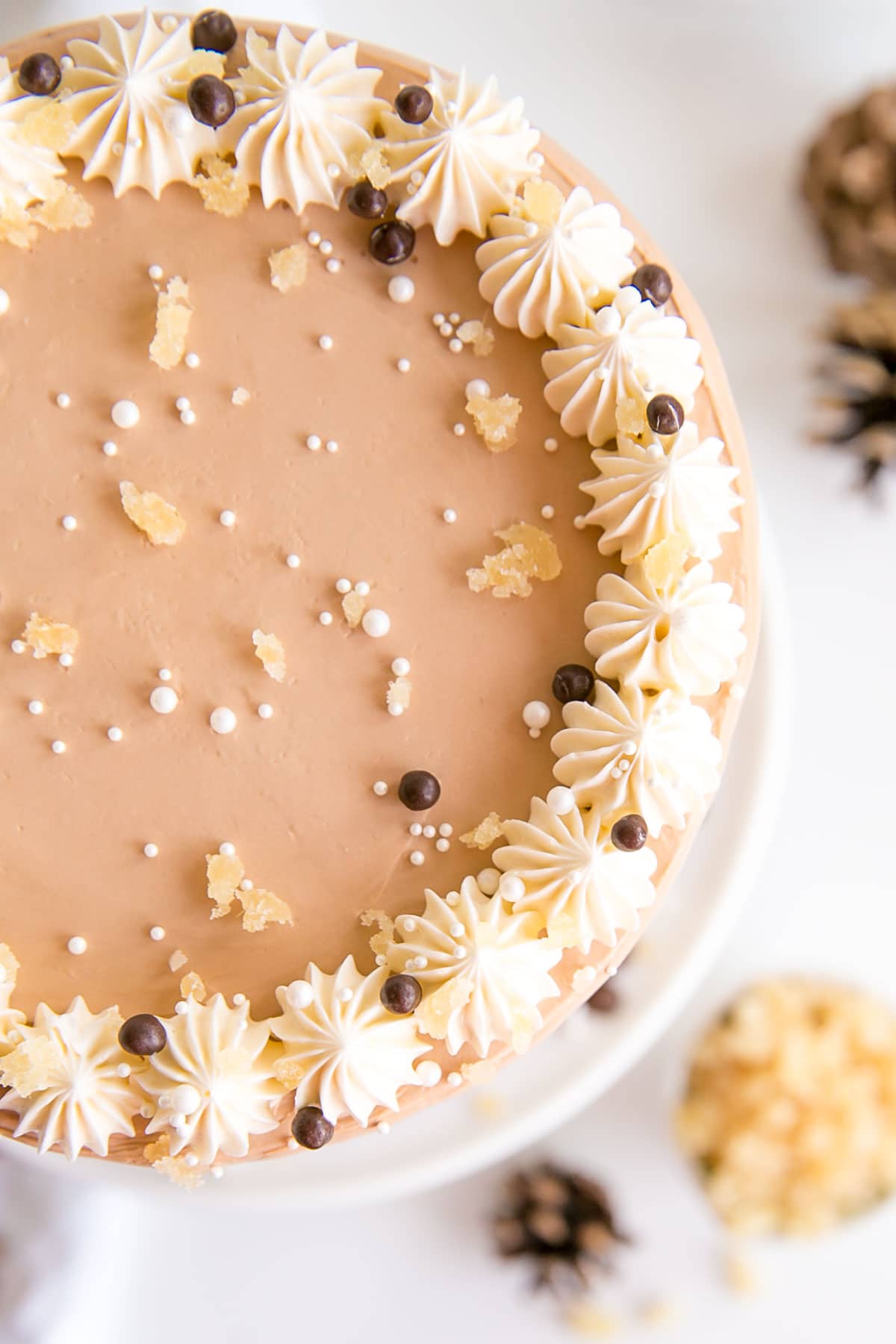 This Gingerbread Latte Cake is your favourite Holiday drink in cake form! Gingerbread spice cake layers with an espresso buttercream. | livforcake.com Overhead shot of the cake showing piping on top.