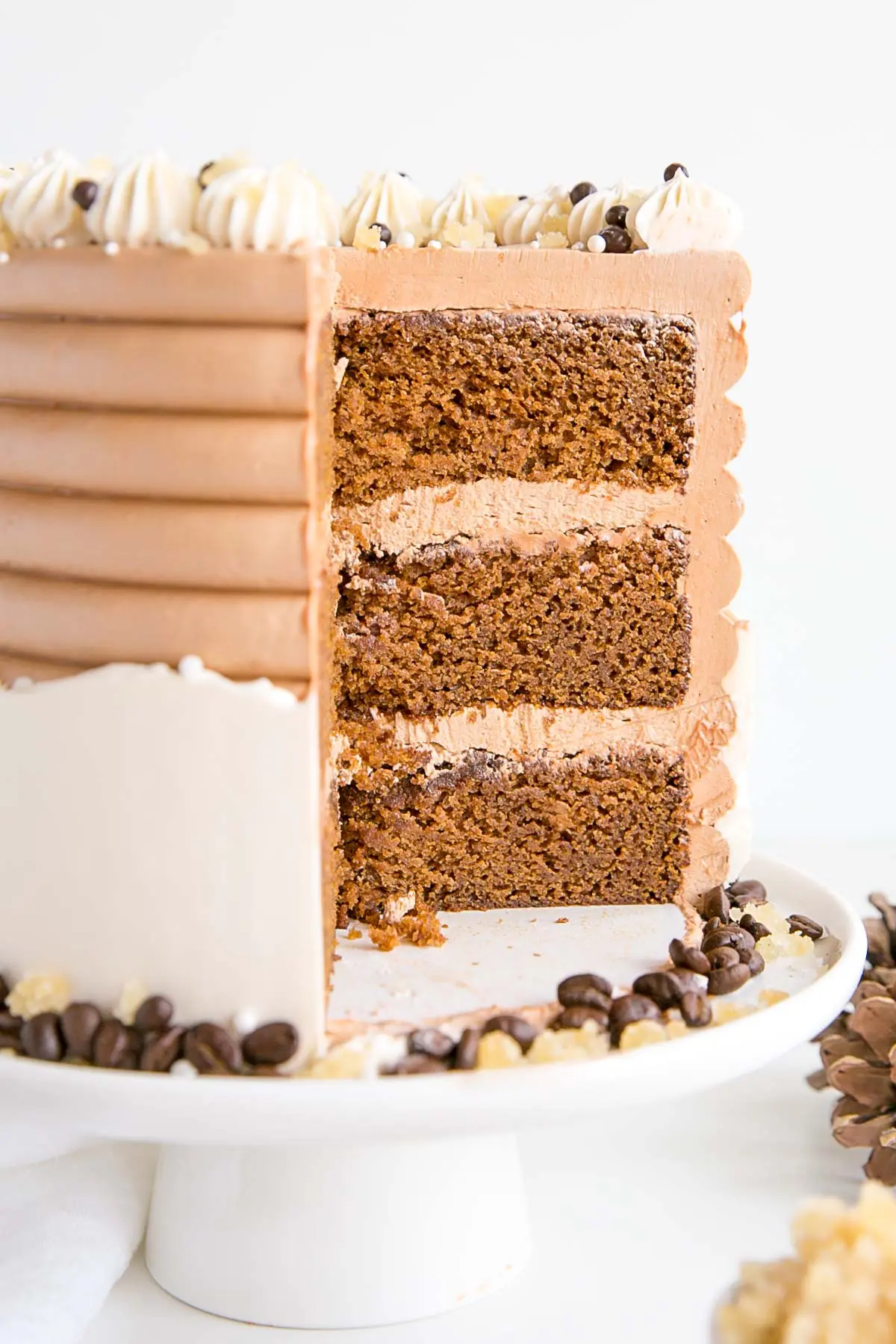This Gingerbread Latte Cake is your favourite Holiday drink in cake form! Gingerbread spice cake layers with an espresso buttercream. | livforcake.com Cross section of the cake showing the gingerbread cake layers.