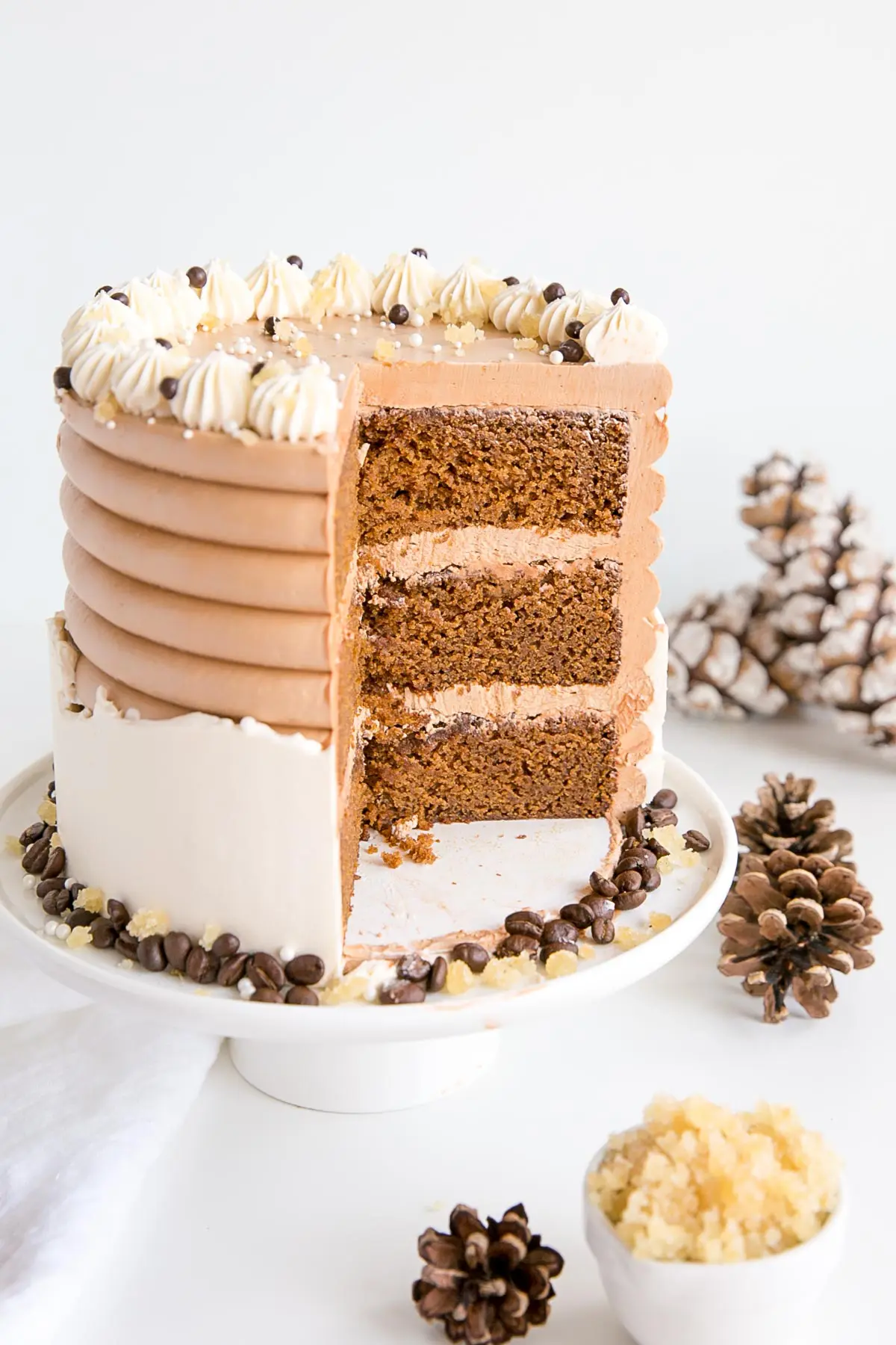 This Gingerbread Latte Cake is your favourite Holiday drink in cake form! Gingerbread spice cake layers with an espresso buttercream. | livforcake.com Angled cross-section shot of the cake.