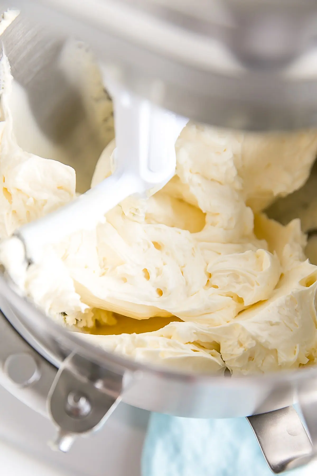 Learn how to make buttercream white with these simple tips & tricks! Perfect for wedding cakes and when you need a white buttercream base to start from. | livforcake.com Whipped butter shown inside the stand mixer.