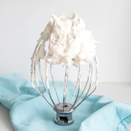 white frosting on a whisk.