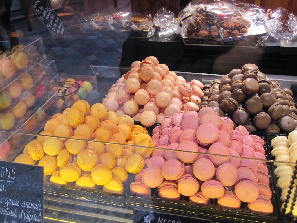 A bunch of macarons on display in a store
