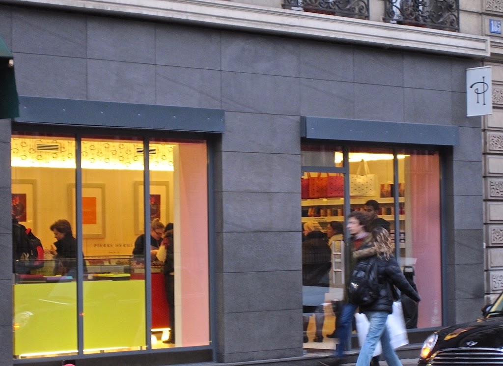 A person walking down a street in front of a store