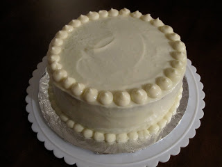 White frosted cake on a table.