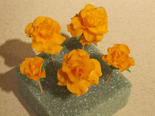 Close up of orange fondant roses.