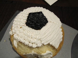 Testing piping techniques on a soccer ball cake.