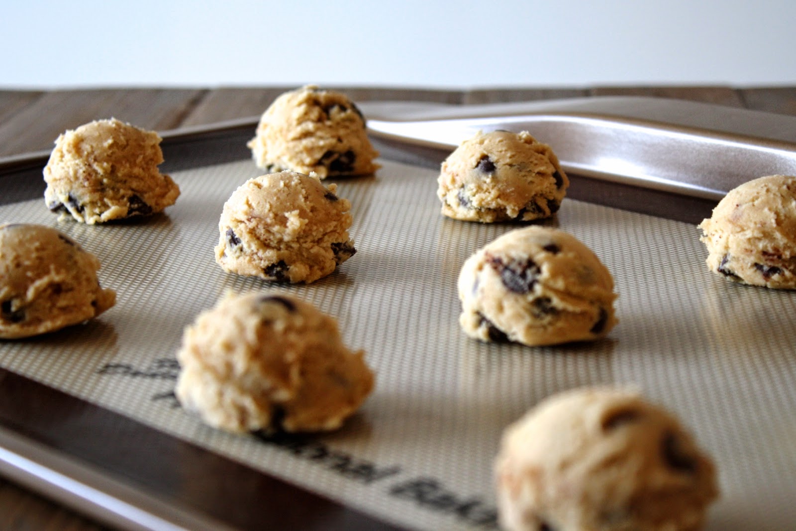 Cookie dough balls on a baking sheet.