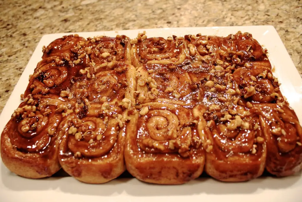 These easy overnight cinnamon rolls are a huge time saver! Make them in advance and pop them in the oven on Christmas morning. | livforcake.com Cinnamon rolls flipped out onto serving dish