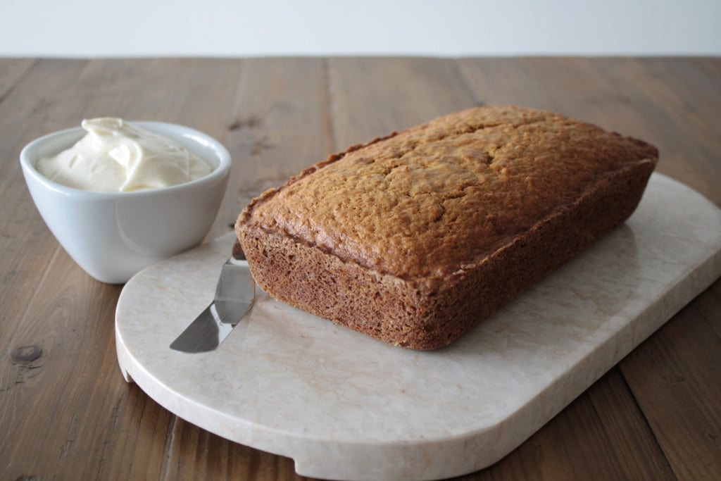 Loaf on a marble slab on a wooden table.