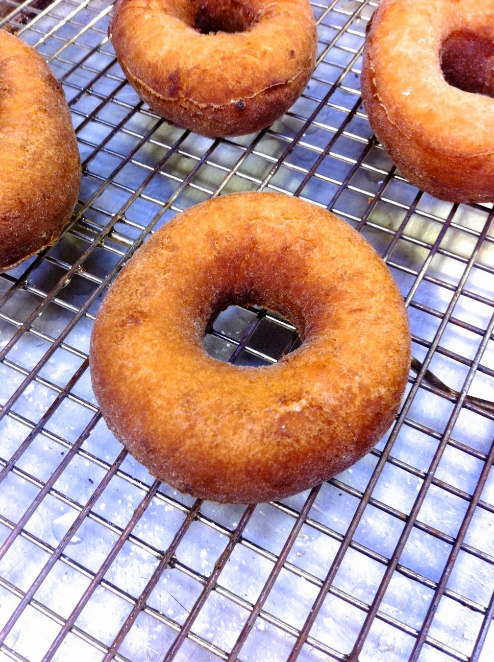 A donut sitting on top of a metal rack