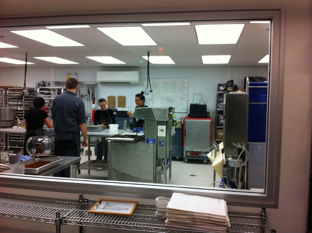 A large commercial kitchen with stainless steel appliances