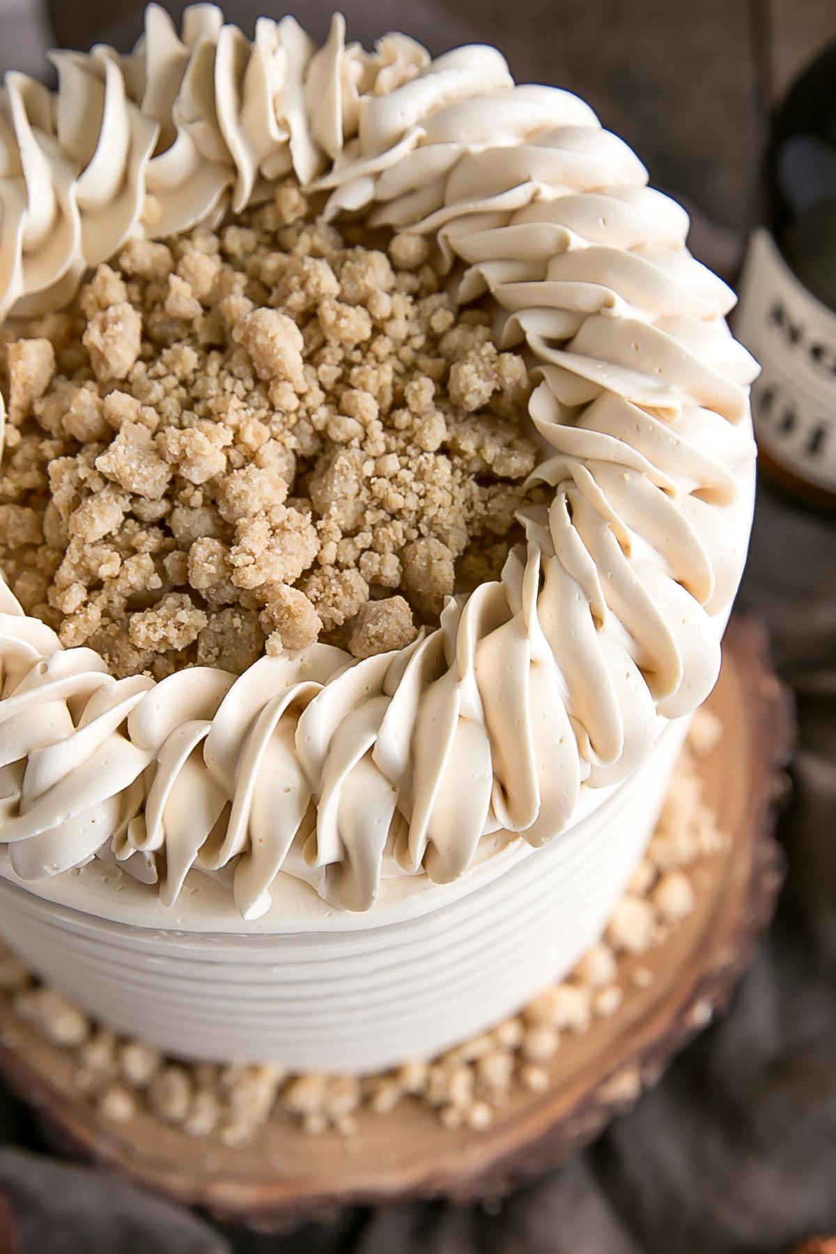 This Maple Cake is packed with pure, natural maple flavour throughout. Maple cake layers with a maple buttercream and maple streusel. | livforcake.com Overhead picture of maple cake showing maple streusel and rope border.