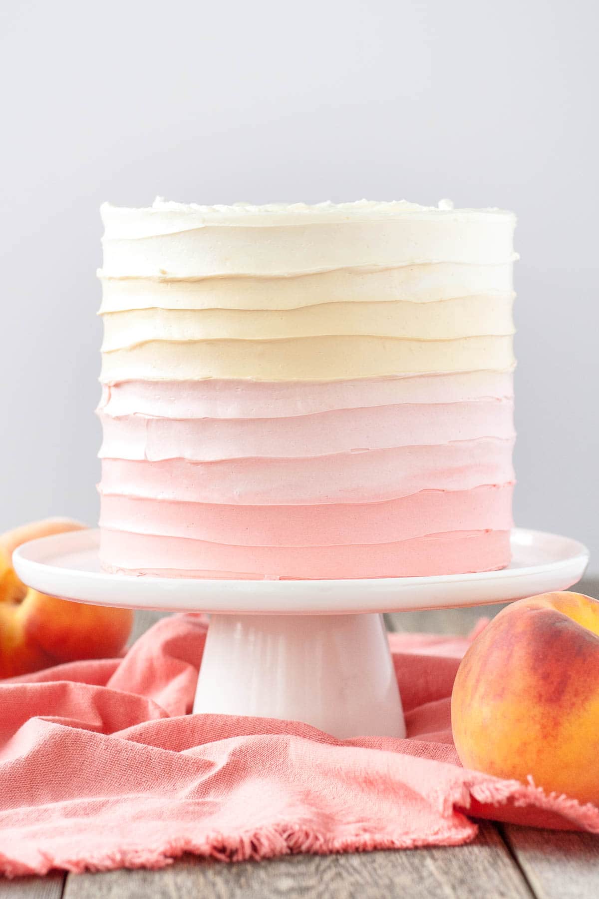 Peach cake with homemade peach filling and ombre peach frosting.