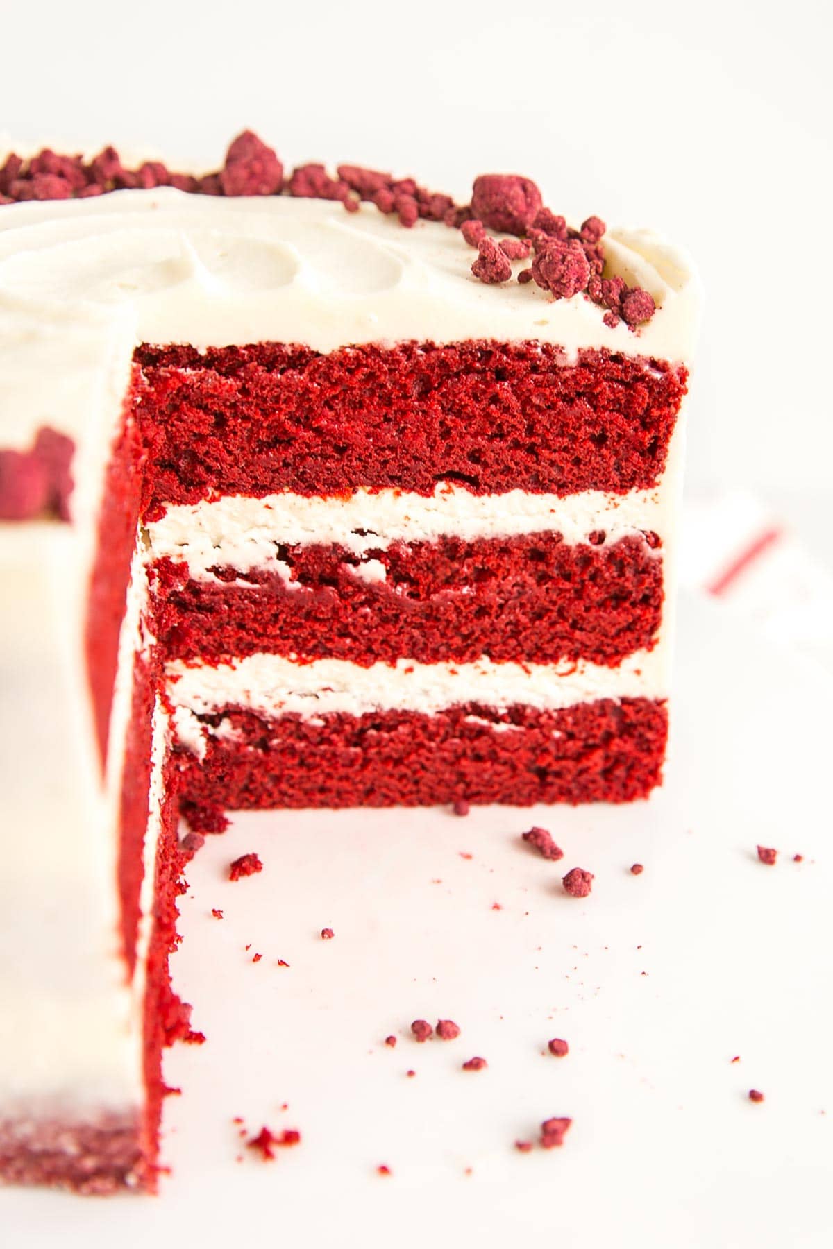 Originally, back in the 1800's, the color of Red Velvet Cake was due to non-Dutched anthocyanin-rich cocoa, which reacted with the vinegar and buttermilk in the recipe to create a rich red/maroon color. These days, even standard cocoa powder from the grocery store has gone through some level of Dutch processing, which strips some of the acid and prevents the color change from happening (at least to the extent that it used to). To compensate, recipes these days use a LOT of red coloring (usually in liquid form) to get that bright or rich red color. Inside of the cake where you can see the red velvet cake layers.