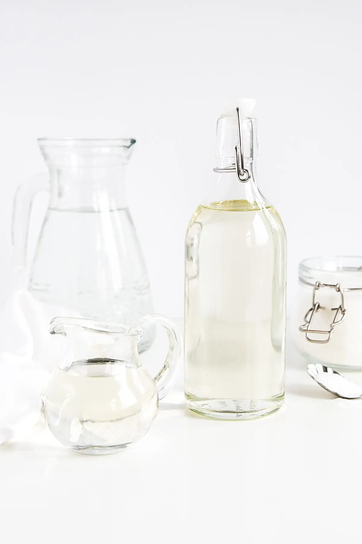 Make simple syrup at home with this quick and easy recipe! The perfect addition to your cakes, cocktails, and iced beverages. | livforcake.com Simple syrup in a bottle shown with water and sugar.